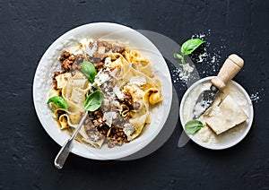 Homemade freshness pappardelle pasta with beef bolognese sauce on a dark background. photo
