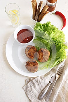 Homemade fried chicken meat cutlets with salade leaves , lettuce and sauce