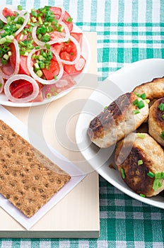 Homemade fried meatballs on a green tablecloth