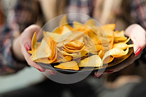 Homemade fried nacho chips food hand offer plate