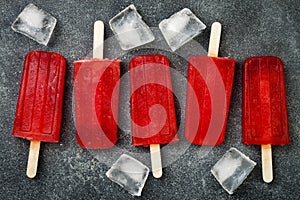 Homemade frozen blood orange natural juice alcoholic popsicles - paletas - ice pops. Overhead, flat lay, top view.