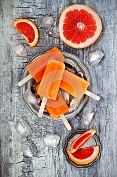 Homemade frozen grapefruit natural juice popsicles.