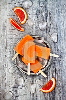 Homemade frozen grapefruit natural juice popsicles.