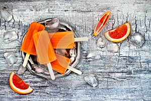 Homemade frozen grapefruit natural juice popsicles.