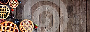 Homemade fruit pies corner border over a rustic wood banner background