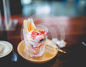 Homemade fruit yoghurt with strawberry jam, apple and conflake