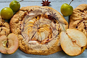 Homemade fruits tart with chocolate topping on the concrete background. Vegetarian healthy autumn dessert - galette with pears