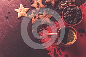 Homemade ginger cookies, cup of tea with lemon, dates, cinnamon with raisins