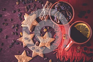 Homemade ginger cookies, cup of tea with lemon, dates, cinnamon with raisins