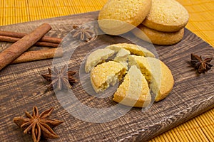 Homemade gingerbread cookies, spices and cutting board on wooden background. holiday.