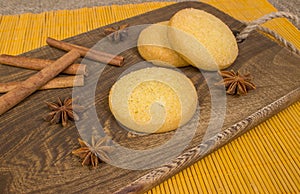 Homemade gingerbread cookies, spices and cutting board on wooden background. holiday.