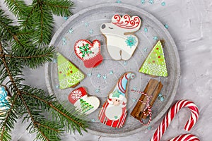 Homemade gingerbread cookies on tray on grunge gray background. Christmas and New Year celebration background