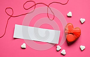 Homemade gingerbread hearts with an empty paper for your text on pink background. Valentine cookies hearts. Edible Valentines Da
