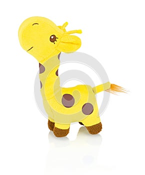 Homemade giraffe plushie doll isolated on white background with shadow reflection. Yellow giraffe plush stuffed puppet on white.