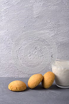 Homemade gluten free cottage cheese rice cookies and glass of milk on gray textured background