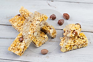 Homemade granola bars with roasted nuts, selective focus, wooden background