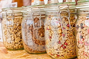 Homemade granola in jar on rustic kitchen table