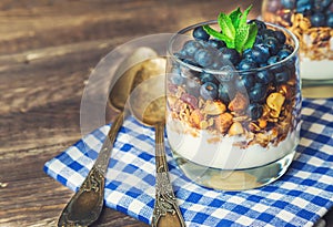Homemade granola, muesli with blueberry and yogurt in glasses