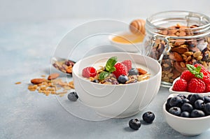 Homemade granola with yogurt and fresh berries, healthy breakfast concept.