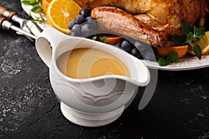 Homemade gravy in a sauce dish with turkey