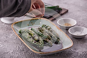 Homemade green chili pepper with soya sauce served on plate