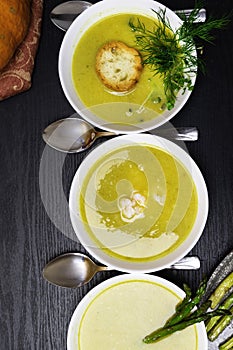 Homemade green cream soup with asparagus, green peas,pumpkin, shrimps