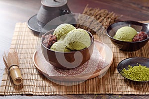 Homemade green tea or matcha ice cream in the wooden bowl and put on bamboo mat