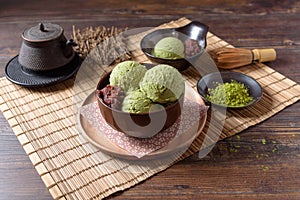 Homemade green tea or matcha ice cream in the wooden bowl and put on bamboo mat