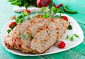 Homemade ground beef meatloaf with ketchup and bell peppers.