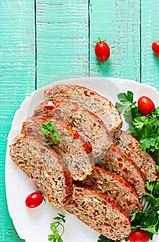 Homemade ground beef meatloaf with ketchup and bell peppers.