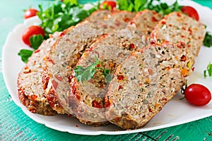 Homemade ground beef meatloaf with ketchup and bell peppers.