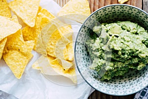 Homemade guacamole with corn chips tortillas - Traditional spicy Mexican preparation