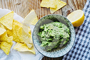 Homemade guacamole with corn chips tortillas - Traditional spicy Mexican preparation