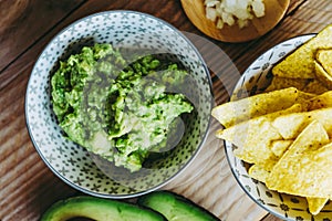 Homemade guacamole with corn chips tortillas - Traditional spicy Mexican preparation