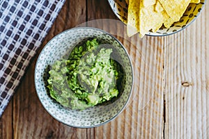 Homemade guacamole with corn chips tortillas - Traditional spicy Mexican preparation