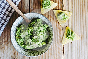 Homemade guacamole with corn chips tortillas - Traditional spicy Mexican preparation