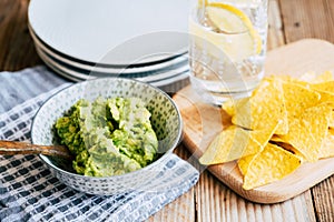 Homemade guacamole with corn chips tortillas - Traditional spicy Mexican preparation