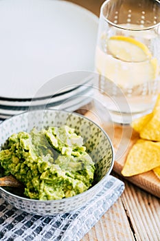 Homemade guacamole with corn chips tortillas - Traditional spicy Mexican preparation