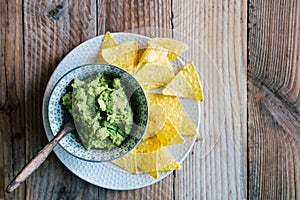 Homemade guacamole with corn chips tortillas - Traditional spicy Mexican preparation