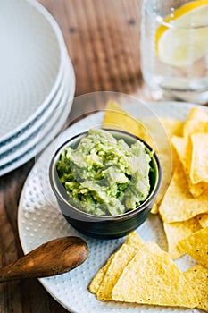 Homemade guacamole with corn chips tortillas - Traditional spicy Mexican preparation