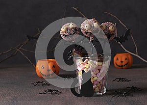 Homemade Halloween cake pops monsters with dark chocolate. Sweets for kids on Halloween party