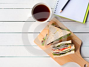 Homemade ham cheese sandwich and coffee cup for breakfast.