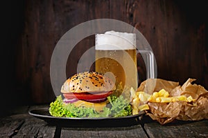 Homemade hamburger with beer and potatoes