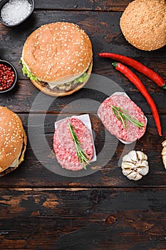 Homemade hamburger with ingredients  on dark wooden background, topview