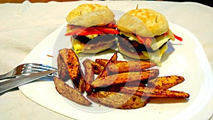 Homemade hamburgers And rustic potatoes.