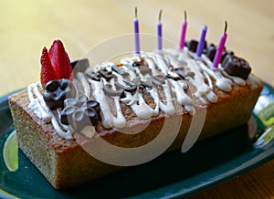 Homemade happy birthday cake with words in spanish made of chocolate photo