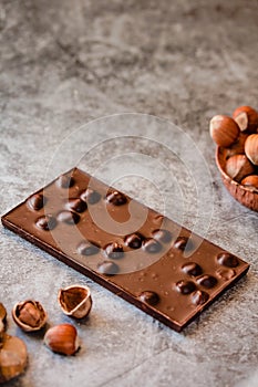 Homemade hazelnut chocolate bar. Nuts and chocolate background. Ingredients for cooking homemade chocolate sweets. Confectionery