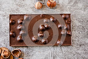 Homemade hazelnut chocolate bar. Nuts and chocolate background. Ingredients for cooking homemade chocolate sweets. Confectionery