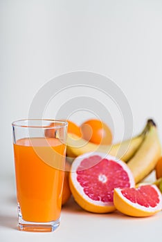 Homemade healthy beverage - multi fruits juice of red, yellow, green, orange fruits on soft light