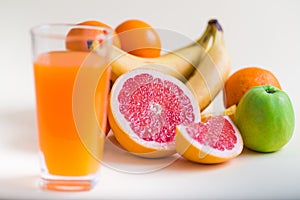 Homemade healthy beverage - multi fruits juice of red, yellow, green, orange fruits on soft light